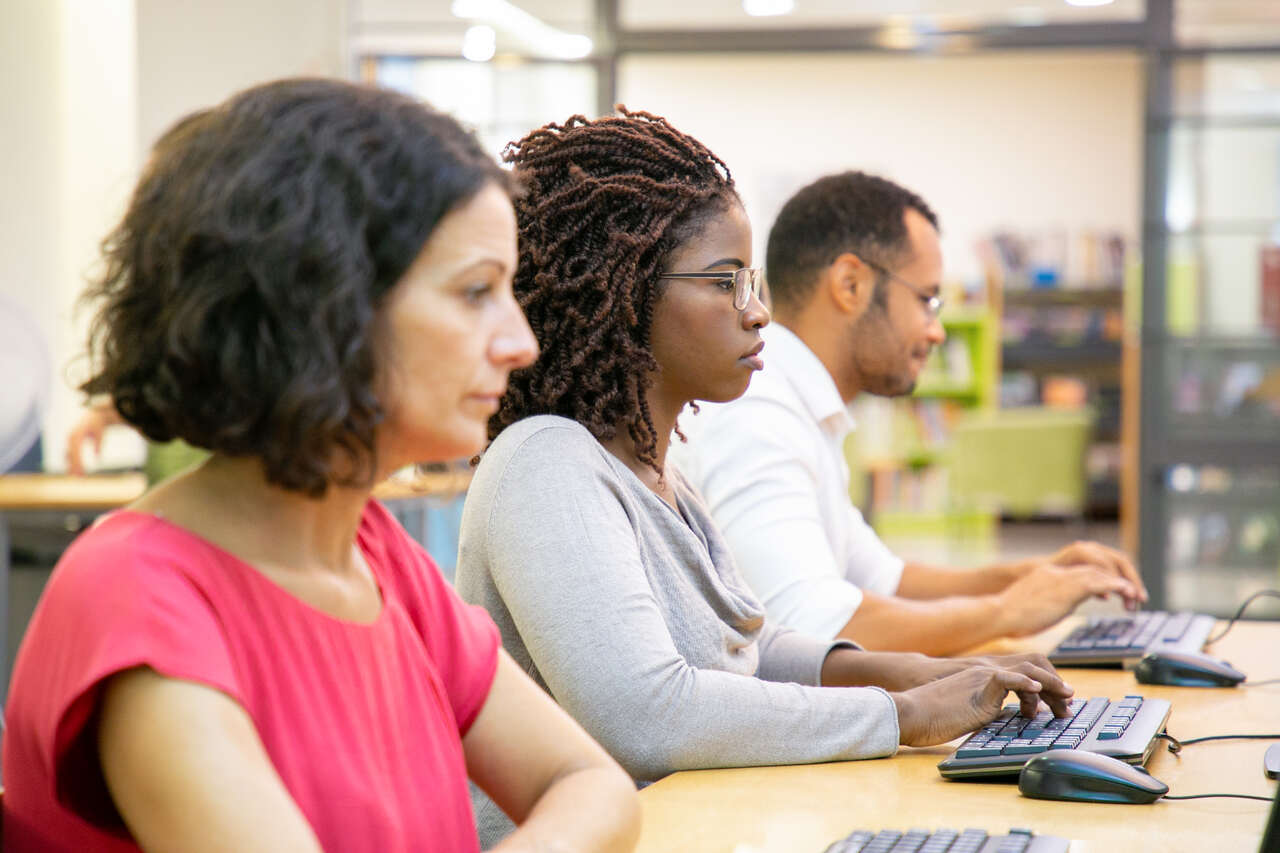 Jovens adultos em aula em laboratório de informática